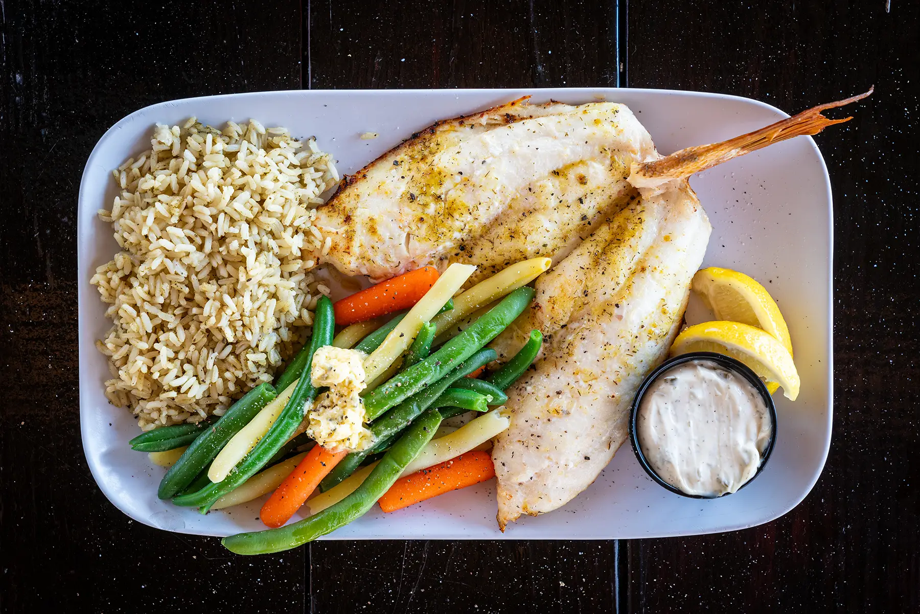 Fresh Seafood Dish at Captain Curt’s Siesta Key Fresh grilled seafood plate with vegetables at Captain Curt’s in Siesta Key near Sarasota